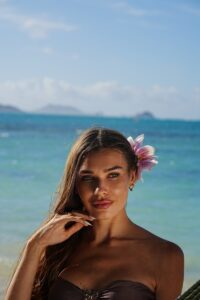 Beautiful woman poses by the ocean.