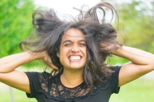 a woman with her hair in the air